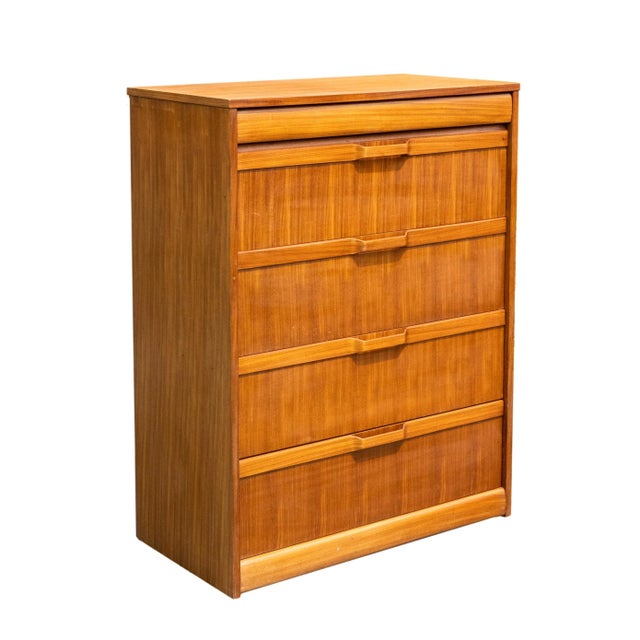Mid-Century Modern teak and elm chest-of-drawers, the top with a 'hidden' frieze drawer in elm, above four large drawers,...