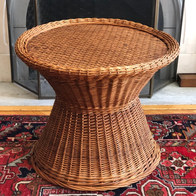 Offering a lovely mid-20th century Boho-style handwoven wicker table. This table features an hourglass shape, French...