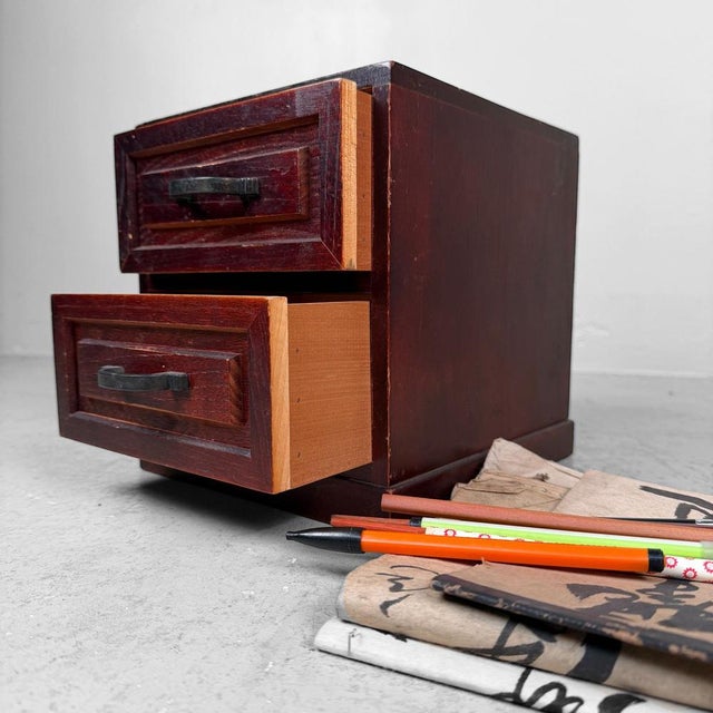 This compact Japanese drawer cabinet features a beautiful, deep reddish-brown tone and a clean, timeless design....