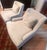 Elegant pair of upholstered armchairs in a neutral cream fabric. these chairs are designed by Barbara Bary for Baker and...