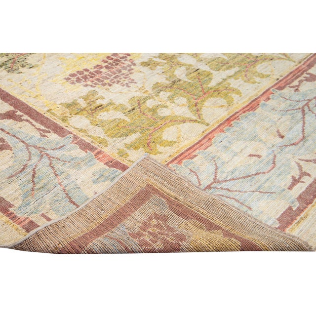 Beautiful modern Oushak hand-knotted wool rug with a blue and beige field. This Oushak rug has pink, blue, and brown...