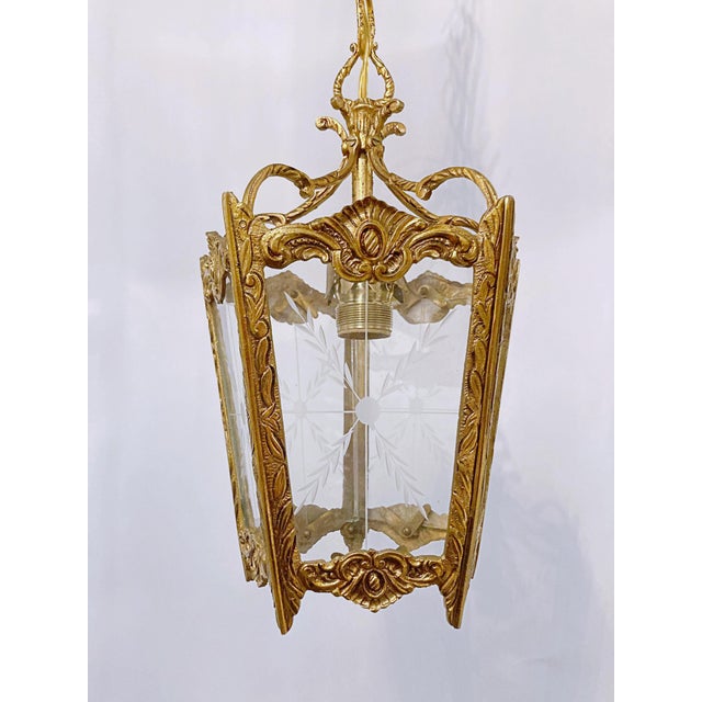 Bronze Lantern With Etched Glass Panels. It has 3 light with candelabra base sockets that each holds a 75W light bulbs or...