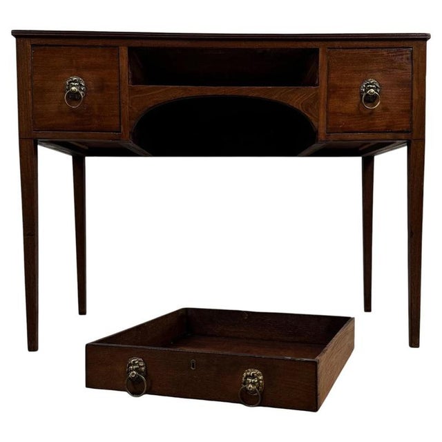 An elegant 18th-century English writing table, finely crafted from mahogany and distinguished by its ebony inlay, reeded...