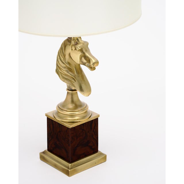 A French table lamp from the mid-century period. This lamp is crafted by Maison Charles and is in the shape of a horse...