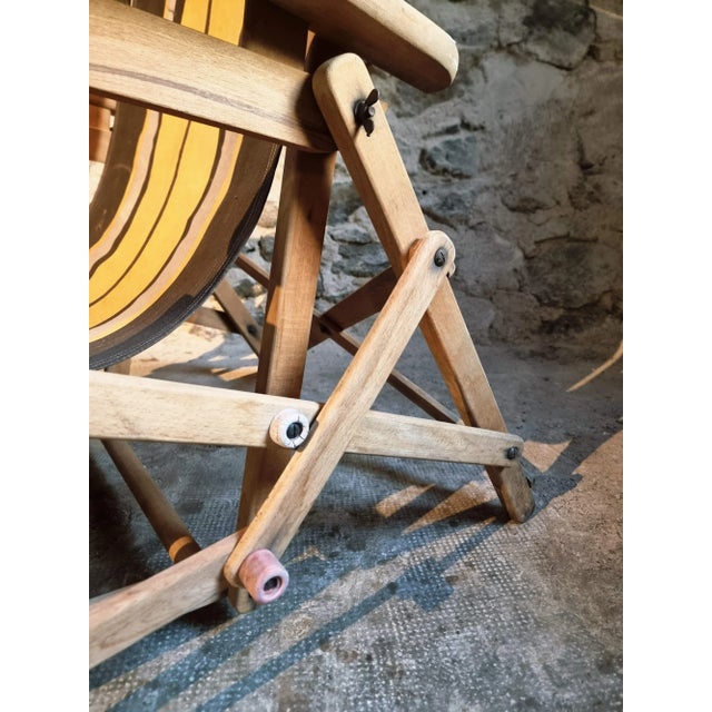 A vintage french deck chair from the 1950s/60s, designed for comfort and style in outdoor living. Crafted with a solid...