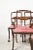 An absolutely gorgeous set of late-19th century regency-style dining chairs, of which two are armchairs. Intricate brass...
