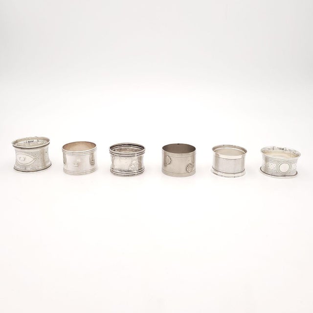 An assembled set of six silver napkin rings, France, 19th century. The larger rings measure 1.675" h x 2.125" d, and the...