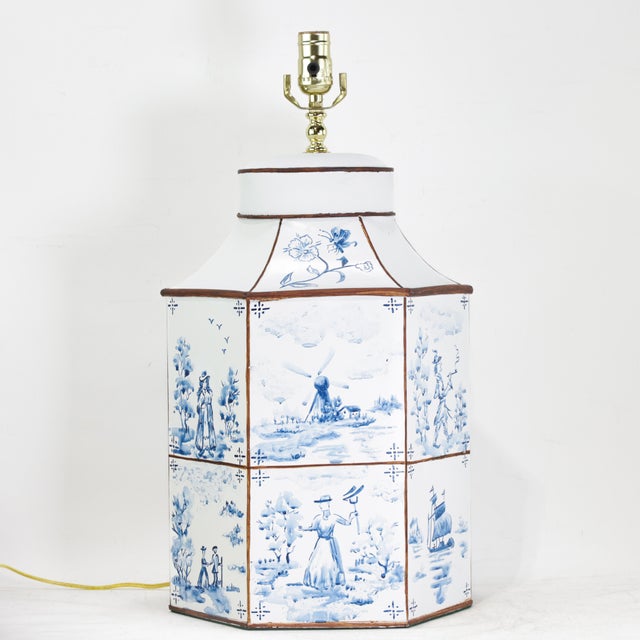 A striking pair of hand-painted Dutch imitation tea caddy lamps, featuring octagonal forms decorated in a traditional...