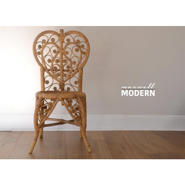 Gorgeous vintage 1970s boho heart back chair with bamboo and rattan. Beautiful scroll details adorn this piece from top to...