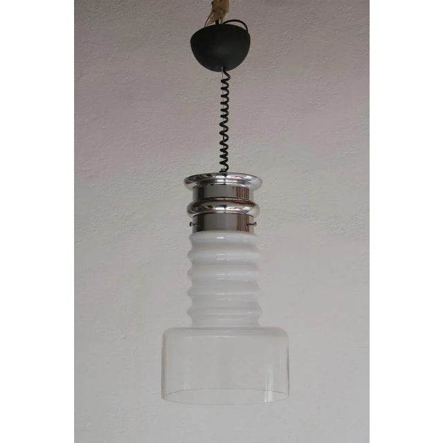 Italian Mid-Century Modern ''Space/Atomic Age'' design pendant Lamp, produced in 1970. This lamp is made of blown glass,...