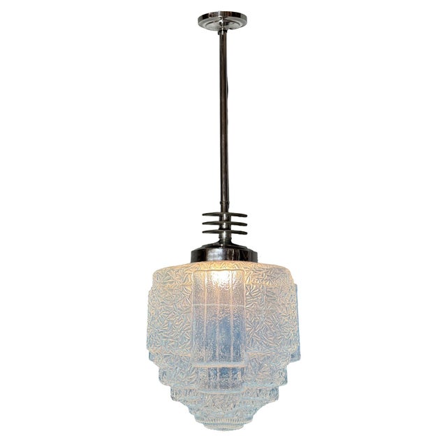 1930s Art Deco pendant light featuring a stepped and line-textured "Skyscraper" blue cobalt glass shade and Streamline Art...