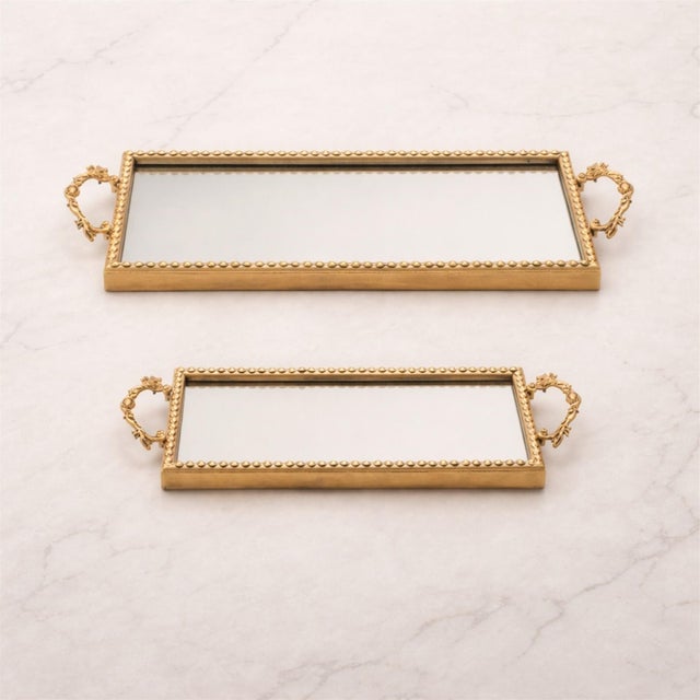 Add a touch of glamour and timeless elegance to your home with this Gold Beaded Mirror Tray Set. Featuring a beautifully...