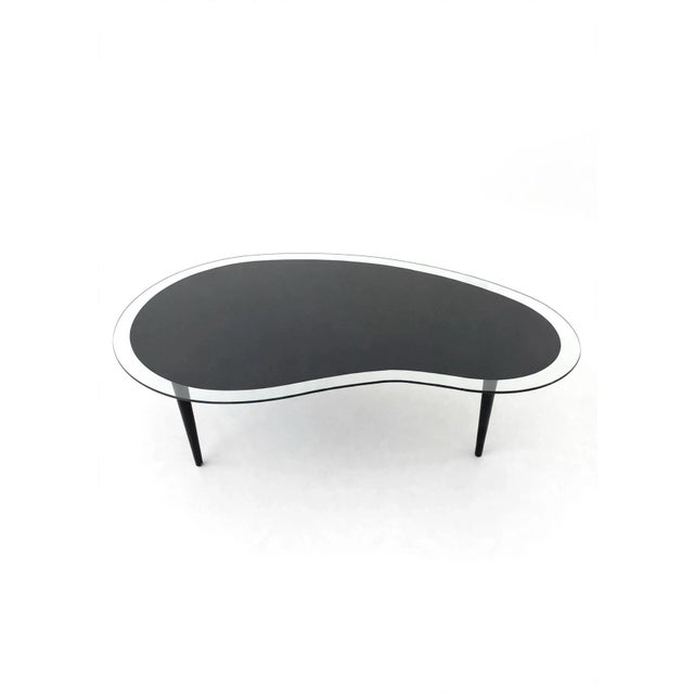 we have for your consideration a 1980s postmodern black and clear glass kidney coffee table. Black wood legs that unscrew....