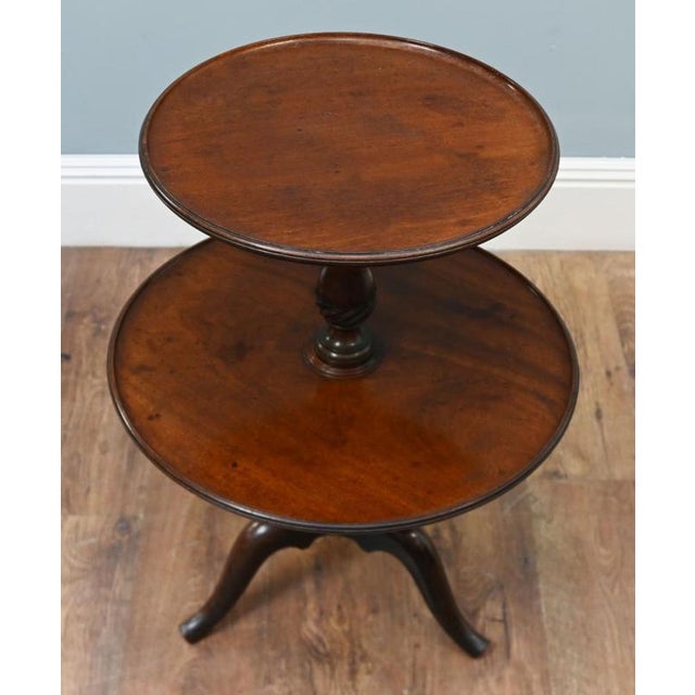 A victorian mahogany two-tier dumb waiter dating to circa 1880. The two circular tiers have raised rims and provide...