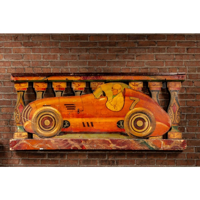 c. 1930s Late Art Deco-early Streamline English carnival ride panel. This vibrant carved wood panel once adorned a car-...