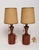 Petite, sculptural pair of solid teak table lamps (ca. 1960s, Denmark). Features a ball on/off pull string, brass sockets,...
