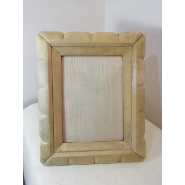 Large photo frame with a wide parchment and carved wood border. This original vintage piece is designed by Aldo Tura....