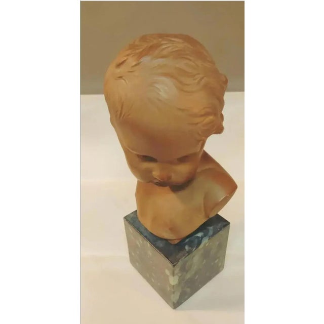 For your consideration . . . Signed petite french bust of a child in the manner of Jean Antoine Houdon. This figural...