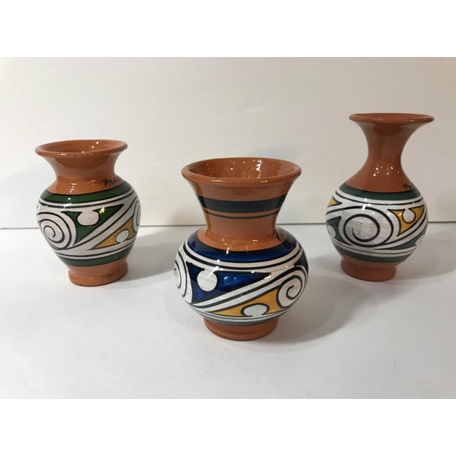 This is a charming set of 3 vases made in Panama. The shiny glaze is awesome on the colorful swirls and lines. The glaze...