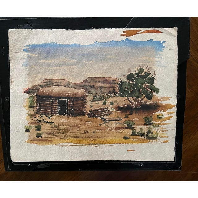 A serene, original watercolor depicting a classic Western log cabin or homestead. The composition focuses on organic...