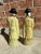 Pair of Chinoisere Asian antique porcelain figures. No cracks or chips. Decorated with butter yellow robes and smiling faces.