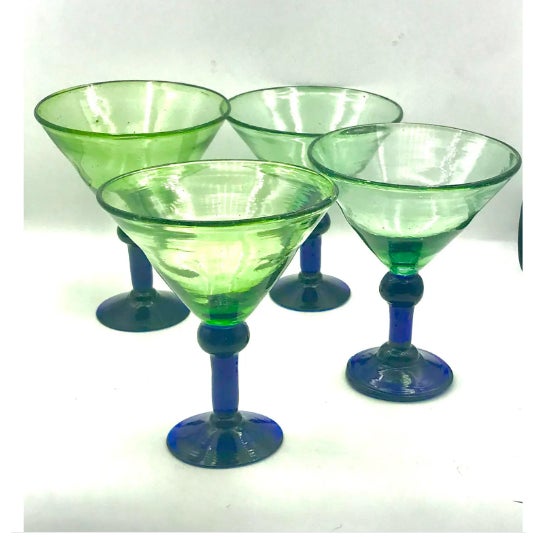 A vibrant set of four vintage Mexican handblown margarita glasses featuring wide, conical bowls in translucent spring...