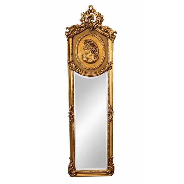 Striking antique heavy gilt pier mirror featuring an exceptionally tall and slender silhouette with elaborate Baroque-...