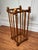 This tall, rectangular open framework umbrella stand is constructed of turned wood rods with ball finials on top, one at...