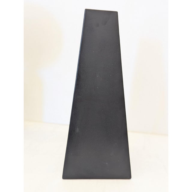 A monumental matte-black vase from Evangeline Pottery (Labelle, Quebec), dating to the 1970s. The form is a tall, tapering...