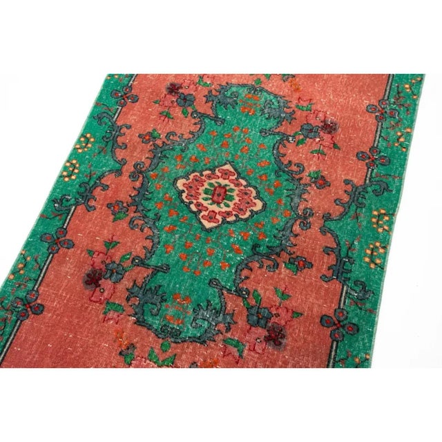 A striking vintage Turkish Oushak-style rug featuring a richly decorative floral medallion design in vibrant emerald...