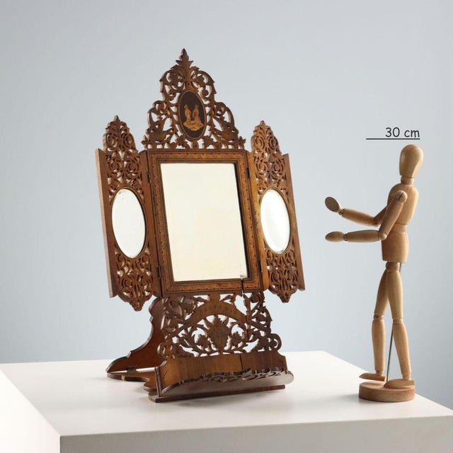 Adjustable, openable freestanding mirror in perforated and inlaid wood. The sides feature scenes of everyday life in...