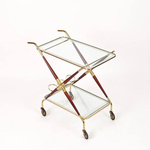Marvelous and unique italian bar cart in a combination of solid brass and deep burgundy lacquered wood, completed by...