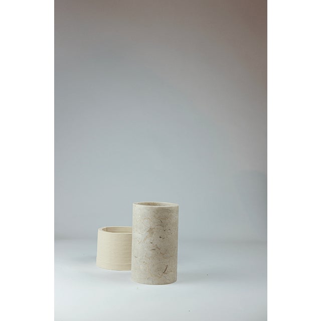 Strand after strand, the clay stratifies like a memory deposited over time. Marble holds the silent weight of ages, of...