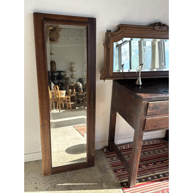 Mirror from an old wardrobe door, with an oak frame. The oak is a warm brown with a textured grain and a waxed patina. The...