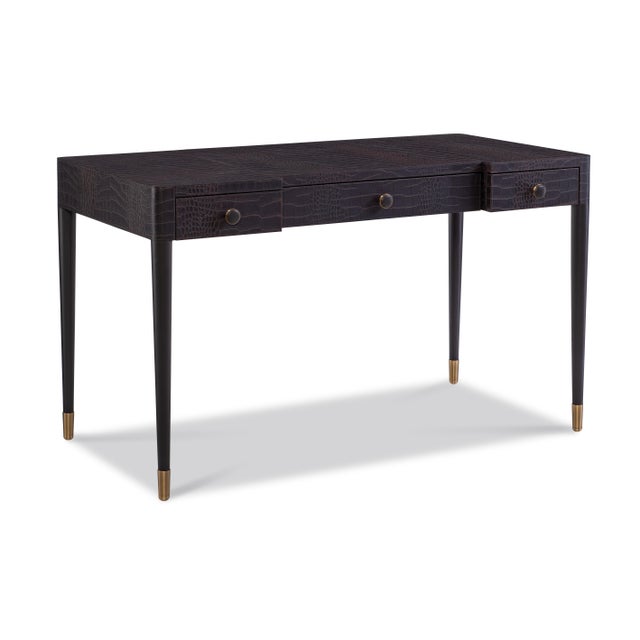 Tailored and tactile, this desk combines sleek form with luxurious texture. Wrapped in embossed leather with a crocodile...