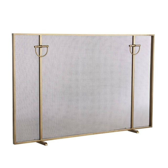 Warm up next to a freshly lit fire while stylishly keeping your space safe. Clean lines frame this antique brass iron...