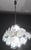 A spectacular Murano chandelier comprising 36 white glass discs. The chandelier features five tiers of discs; the...