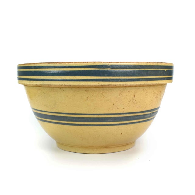 Stunning rare early 20th century yellow stoneware mixing bowl with dark blue bands. It is a perfect addition to any...