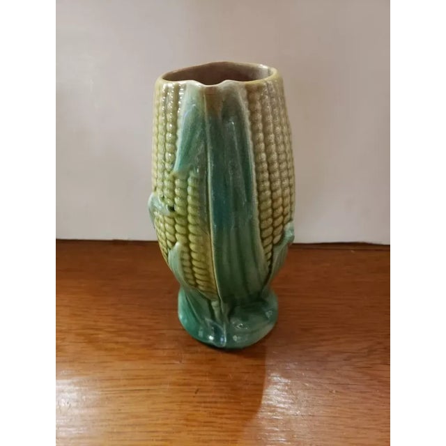 This is an Antique Circa 1880 Majolica Corn Husk Pitcher. It measures 7 1/4" high, 3 3/4" deep and 4 3/4" wide to the...