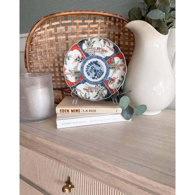 A beautiful vintage Imari-style porcelain plate rendered in a classic Chinoiserie palette of cobalt blue, rust red, soft...