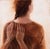 The Sea Within by Ken Cunningham | Oil on cradled panel painting of a woman from behind with hands on her shoulders For Sale