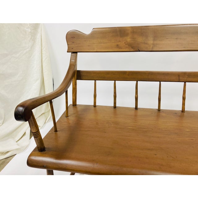 A beautifully crafted early American deacon’s bench in solid maple, featuring classic spindle-back construction and gently...
