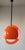 Iconic pendant lamp attributed to Guzzini, made of molded plastic with an all-orange finish. The diffuser features a...