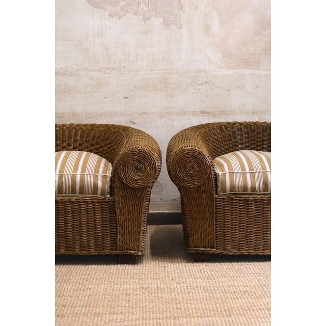 Pair of bergère armchairs by Vivai del Sud, made in the 1970s. Fully woven wicker structure with a curved wraparound back...