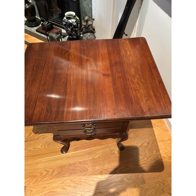 This table has drop leaf sides and two upper drawers with brass pulls. The drop leaf sides are supported with high quality...