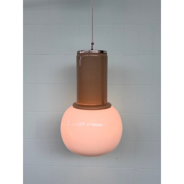 Vintage 1960s/70s Space Age-style pendant lamp featuring a spherical diffuser in milky white opal glass and a distinctive...