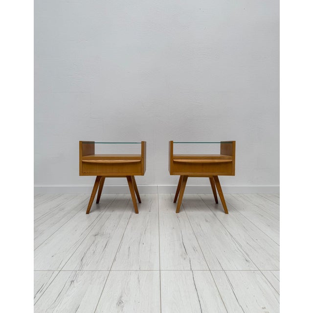 Elegant pair of Mid-Century nightstands dating from the 1960s. The design combines clean geometric lines with practical...