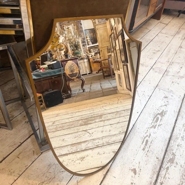 This elegant Italian wall mirror captures the sophisticated essence of 1950s Mid-Century Modern design, heavily inspired...