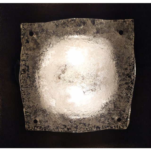 This Wall light Is attributed to Mazzega for form and style. Murano transpatent glass handmade. The steel base with small...