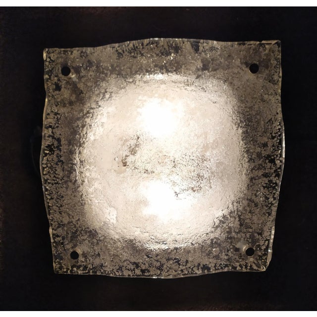 This Wall light Is attributed to Mazzega for form and style. Murano transpatent glass handmade. The steel base with small...